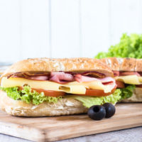 Ciabatta sandwich with bacon and cheese on wooden boarde,selective focus and blank space
